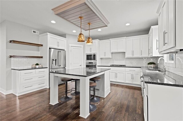 7295 NW Forest Lakes Dr, Parkville, MO 64152 - kitchen featuring stainless steel appliances, open shelves, tasteful backsplash, white cabinetry, and recessed lighting