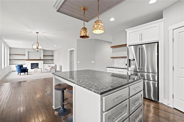 7295 NW Forest Lakes Dr, Parkville, MO 64152 - kitchen featuring high end refrigerator, dark wood finished floors, a center island, white cabinetry, and decorative light fixtures