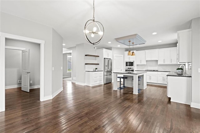 7295 NW Forest Lakes Dr, Parkville, MO 64152 - kitchen featuring stainless steel appliances, open shelves, dark countertops, a chandelier, and a center island