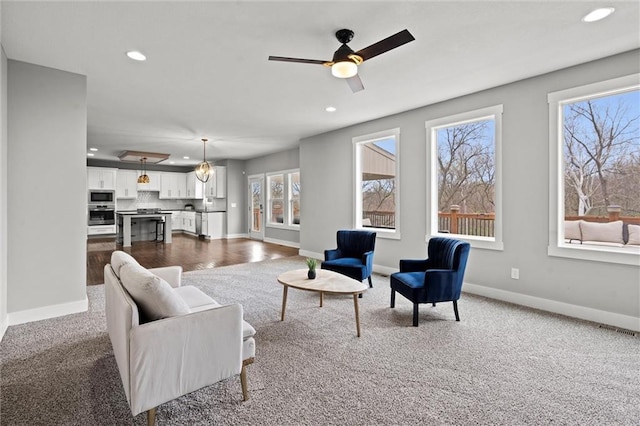 7295 NW Forest Lakes Dr, Parkville, MO 64152 - living room with recessed lighting, dark colored carpet, and a ceiling fan