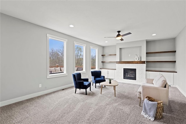 7295 NW Forest Lakes Dr, Parkville, MO 64152 - carpeted living area featuring a high end fireplace, ceiling fan, and recessed lighting