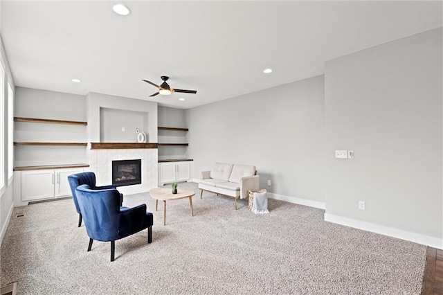7295 NW Forest Lakes Dr, Parkville, MO 64152 - carpeted living area featuring a ceiling fan, a tiled fireplace, and recessed lighting