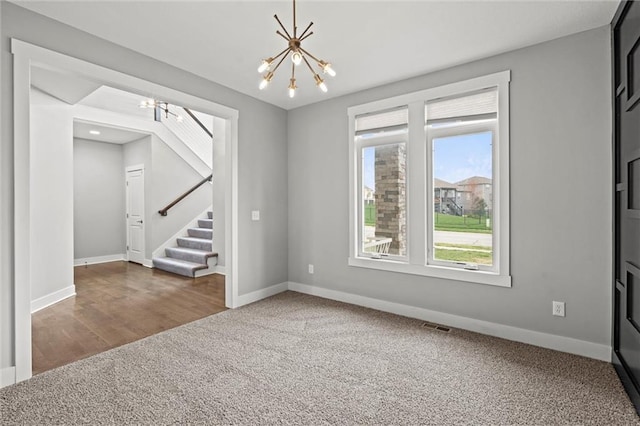 7295 NW Forest Lakes Dr, Parkville, MO 64152 - carpeted spare room featuring a chandelier and stairs