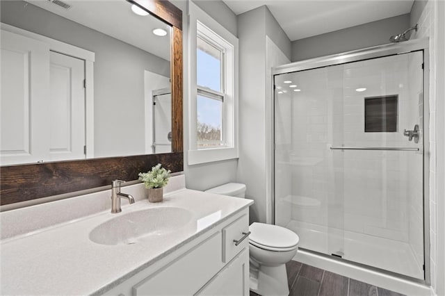 7295 NW Forest Lakes Dr, Parkville, MO 64152 - full bath with vanity, a stall shower, wood finished floors, and recessed lighting