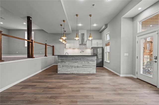 7295 NW Forest Lakes Dr, Parkville, MO 64152 - kitchen with freestanding refrigerator, wall chimney exhaust hood, white cabinetry, recessed lighting, and dark wood-style flooring