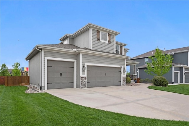 view of front of property featuring fence, concrete driveway, a garage, and a front yard