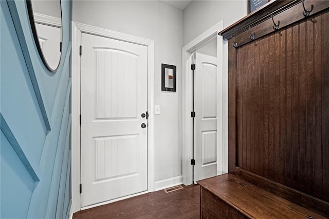 mudroom featuring baseboards, visible vents, and dark wood-style floors