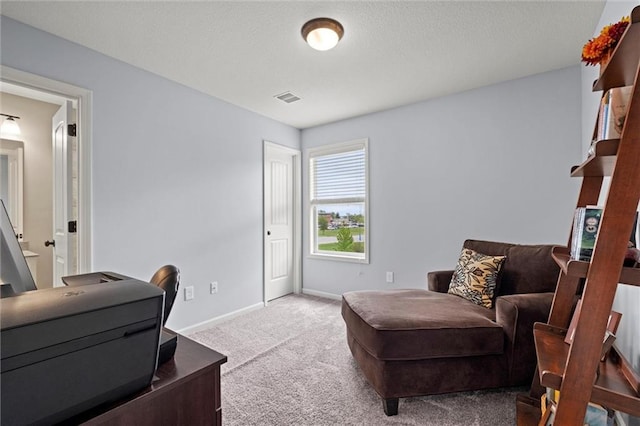 living area with carpet floors, baseboards, and visible vents