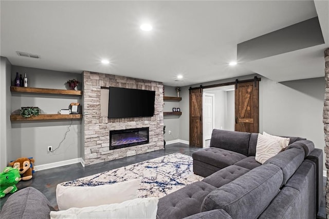 living room with recessed lighting, baseboards, visible vents, and a barn door