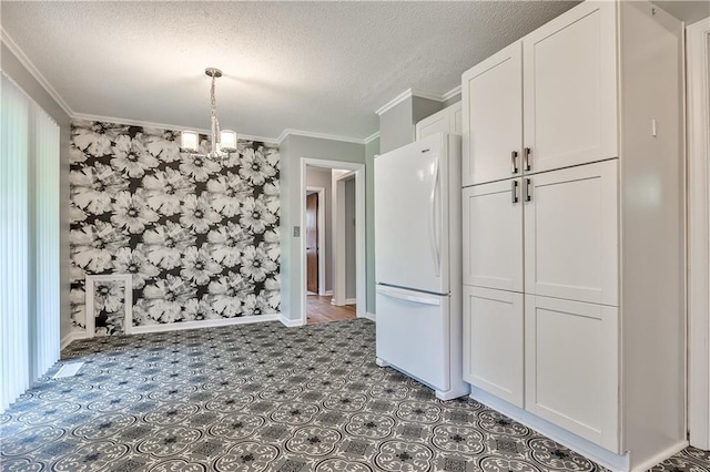 10408 E 28th Ter S, Independence, MO 64052 - unfurnished dining area with a textured ceiling, ornamental molding, baseboards, and a chandelier