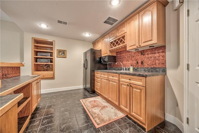 12207 England St, Overland Park, KS 66213 - kitchen featuring a sink, dark countertops, backsplash, and visible vents