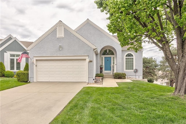 12207 England St, Overland Park, KS 66213 - view of front facade with concrete driveway, an attached garage, a front lawn, and stucco siding
