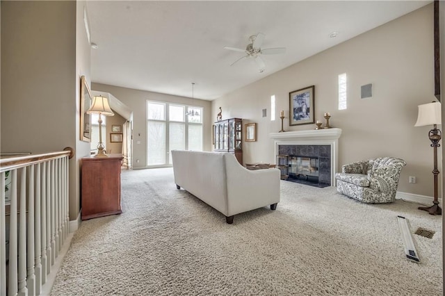 12207 England St, Overland Park, KS 66213 - carpeted living area featuring a tile fireplace, baseboards, and a ceiling fan