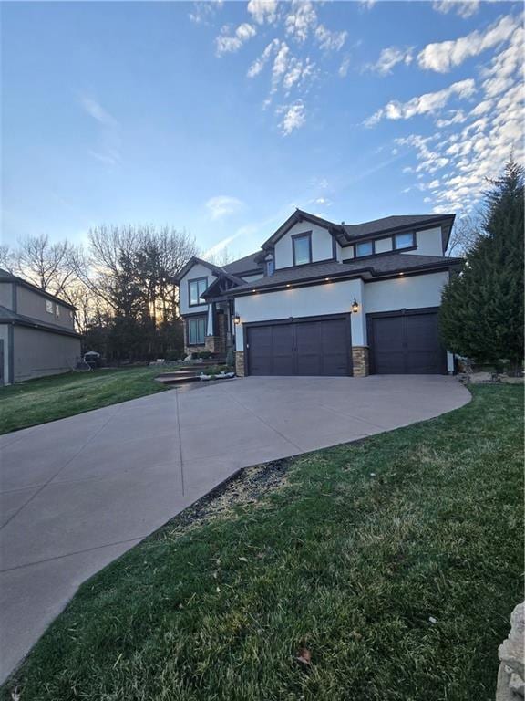 view of front of house with a front yard, stone siding, concrete driveway, stucco siding, and a garage