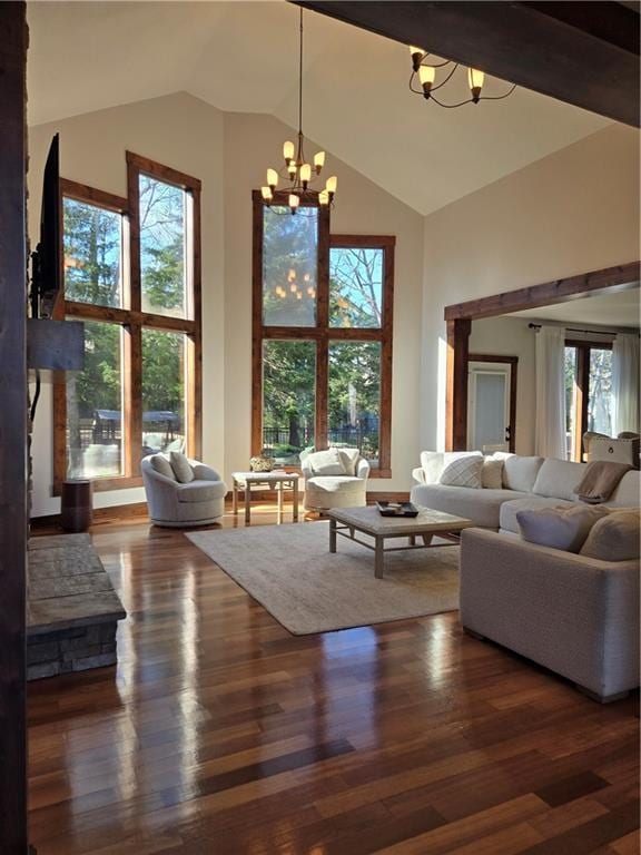 living room featuring high vaulted ceiling, wood finished floors, and a notable chandelier