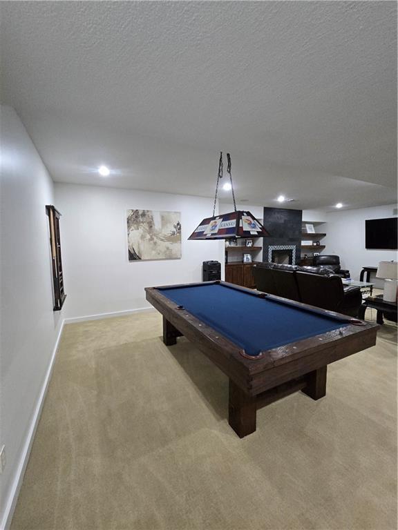 playroom with baseboards, carpet, pool table, and a textured ceiling