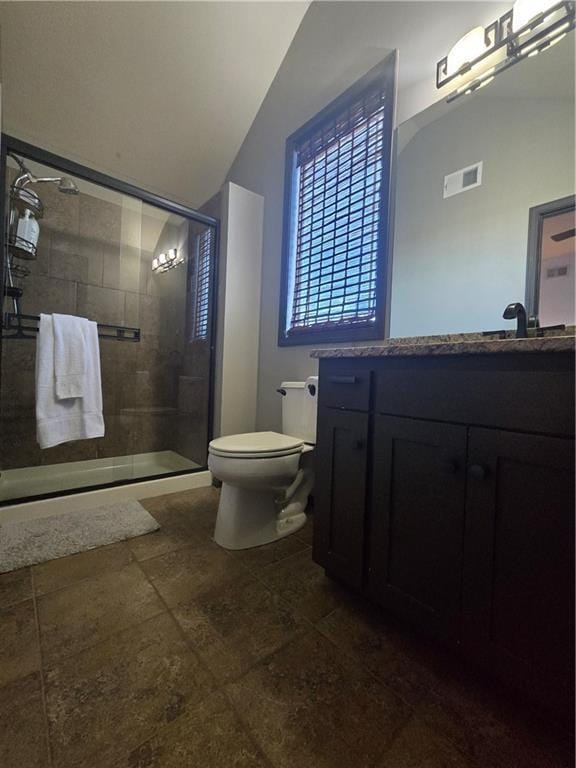 full bathroom featuring visible vents, a shower stall, toilet, vanity, and vaulted ceiling