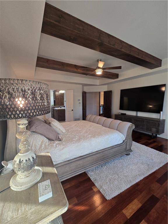 bedroom featuring beamed ceiling, ceiling fan, and wood finished floors