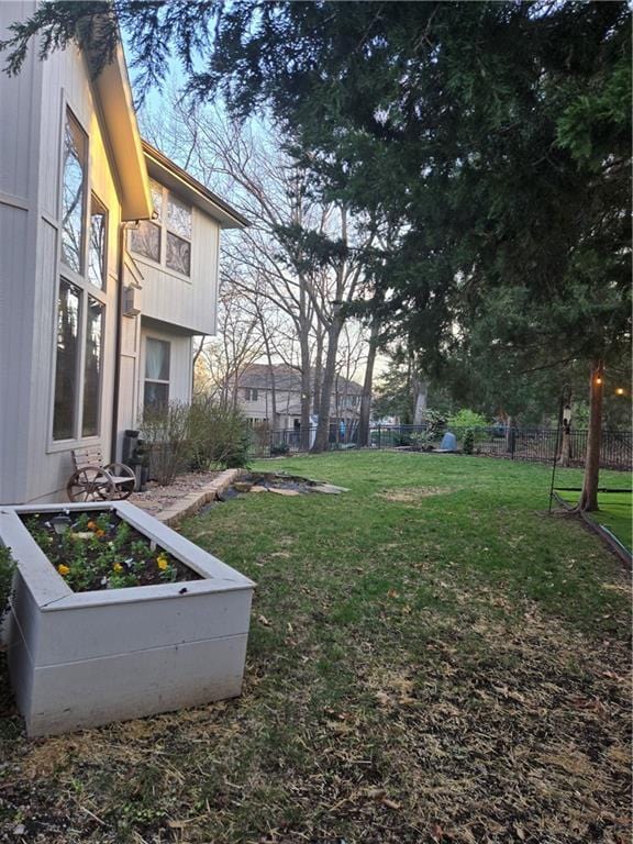 view of yard featuring a vegetable garden and fence