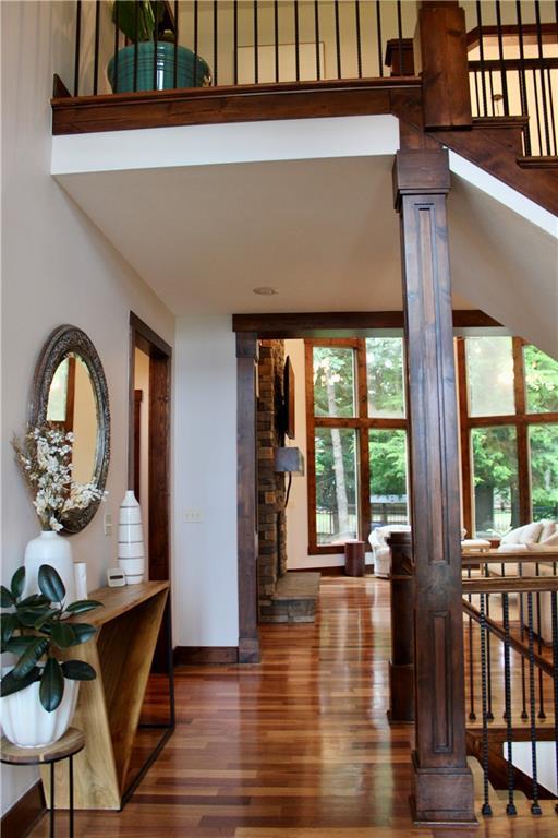 6822 Woodstock Ct, Shawnee, KS 66218 - foyer entrance featuring wood finished floors and decorative columns