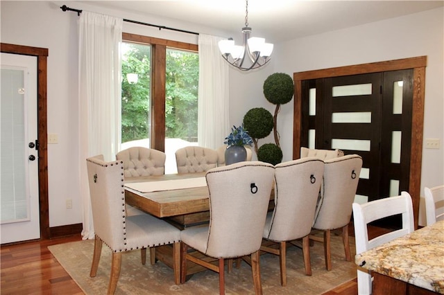 6822 Woodstock Ct, Shawnee, KS 66218 - dining room featuring a chandelier and wood finished floors