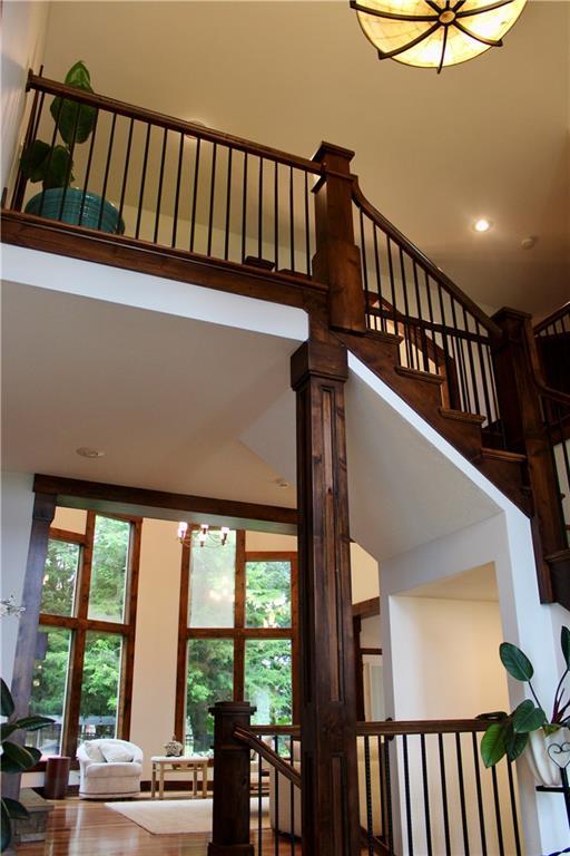 6822 Woodstock Ct, Shawnee, KS 66218 - stairway with a towering ceiling, a chandelier, and recessed lighting