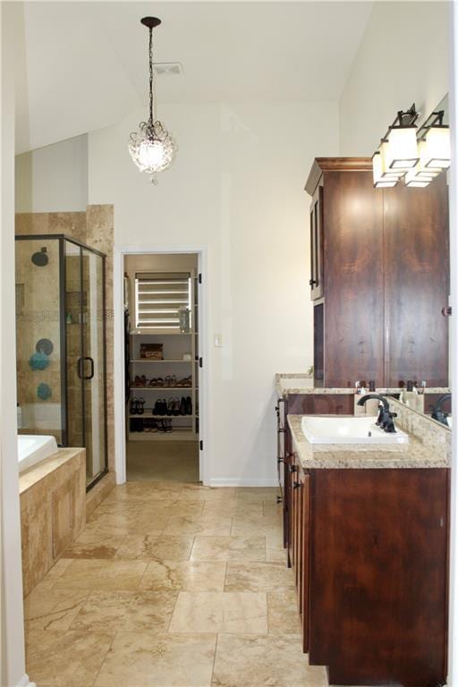 6822 Woodstock Ct, Shawnee, KS 66218 - full bathroom with a shower stall, vanity, a garden tub, lofted ceiling, and a spacious closet