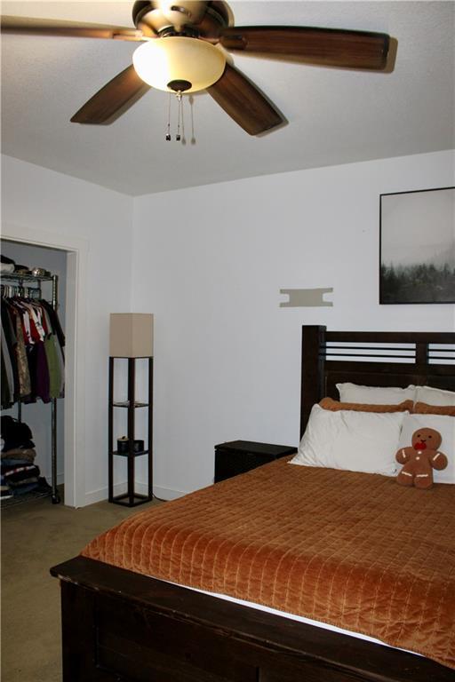 6822 Woodstock Ct, Shawnee, KS 66218 - carpeted bedroom with a closet and a ceiling fan