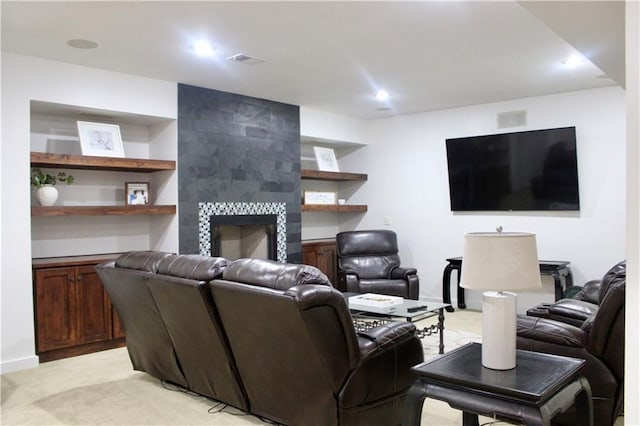 6822 Woodstock Ct, Shawnee, KS 66218 - living area featuring light colored carpet, a tiled fireplace, built in shelves, and recessed lighting