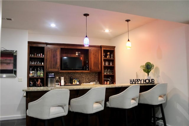 6822 Woodstock Ct, Shawnee, KS 66218 - indoor wet bar with backsplash, pendant lighting, dark tile patterned floors, and recessed lighting