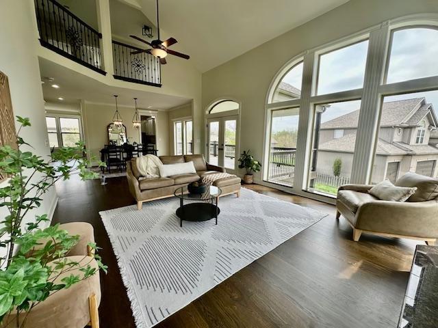 living room with french doors, wood finished floors, high vaulted ceiling, and ceiling fan