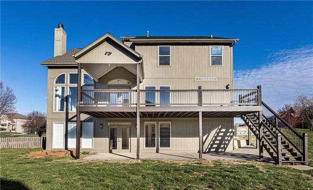 back of house with a patio, a chimney, stairway, a wooden deck, and a yard