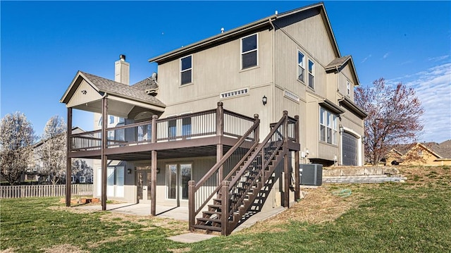 rear view of house with a yard, stairway, a patio, fence, and a deck