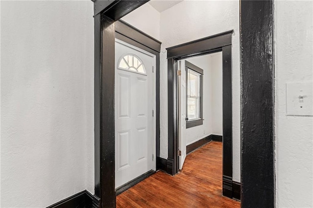 2905 Wabash Ave, Kansas City, MO 64109 - foyer with a textured wall, dark wood-style floors, and baseboards