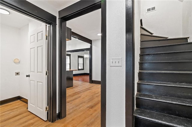 2905 Wabash Ave, Kansas City, MO 64109 - stairway with wood finished floors, baseboards, and visible vents