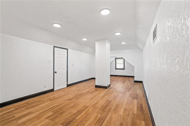 2905 Wabash Ave, Kansas City, MO 64109 - bonus room featuring visible vents, baseboards, a textured wall, recessed lighting, and light wood-style flooring