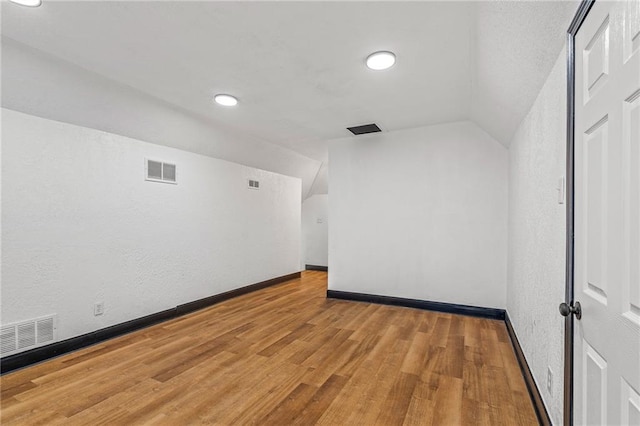2905 Wabash Ave, Kansas City, MO 64109 - bonus room with visible vents, baseboards, wood finished floors, and vaulted ceiling