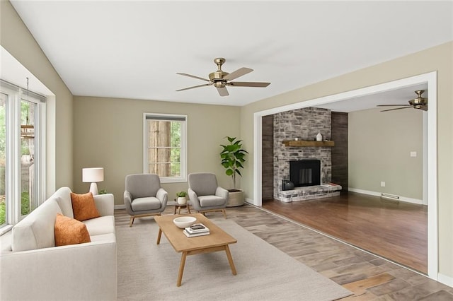 8813 W 106th Cir, Overland Park, KS 66212 - living room with ceiling fan, wood finished floors, a fireplace, and baseboards
