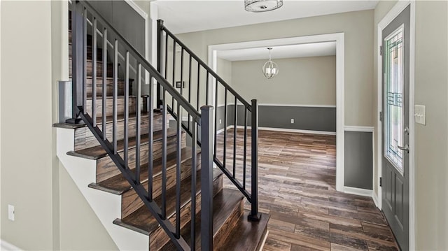 8813 W 106th Cir, Overland Park, KS 66212 - foyer with dark wood-style floors, stairs, and a chandelier
