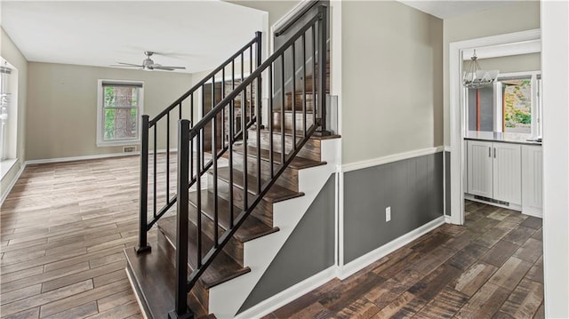 8813 W 106th Cir, Overland Park, KS 66212 - stairway with wood finished floors, a ceiling fan, baseboards, and a chandelier