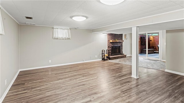 8813 W 106th Cir, Overland Park, KS 66212 - below grade area featuring a brick fireplace, wood finished floors, crown molding, and baseboards