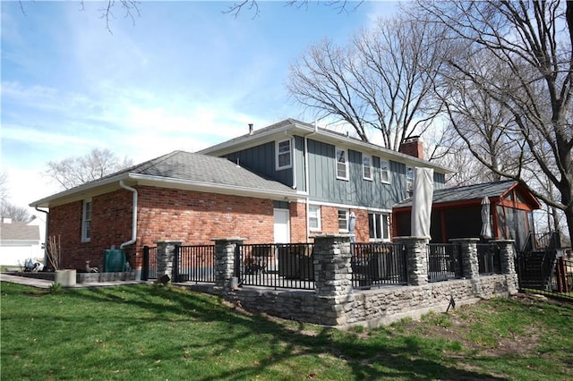 8813 W 106th Cir, Overland Park, KS 66212 - back of house with a chimney, brick siding, and board and batten siding
