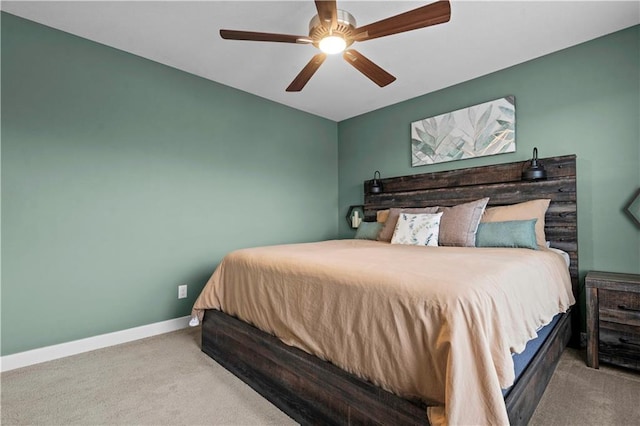 carpeted bedroom featuring a ceiling fan and baseboards