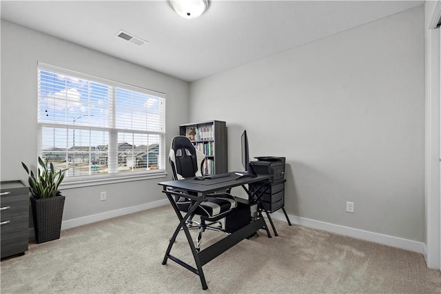 office with baseboards, light colored carpet, and visible vents