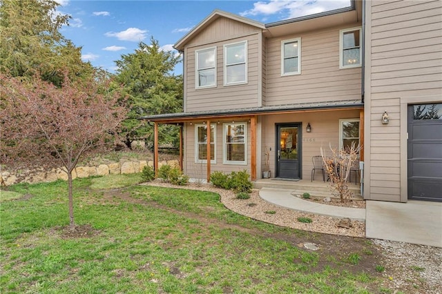 4866 Dabinawa Dr, Mclouth, KS 66054 - view of front of house with a front lawn, a porch, and a garage