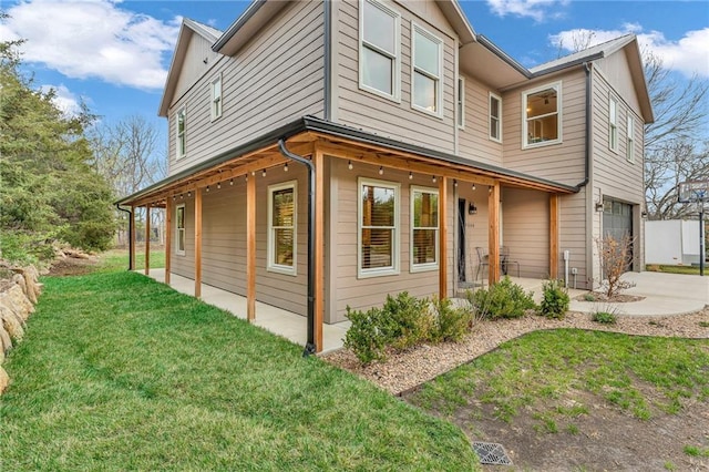 4866 Dabinawa Dr, Mclouth, KS 66054 - view of home's exterior featuring a patio area, concrete driveway, a yard, and an attached garage