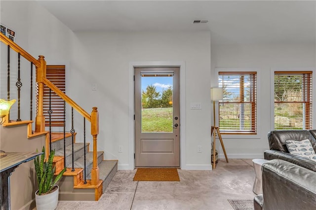 4866 Dabinawa Dr, Mclouth, KS 66054 - foyer entrance featuring baseboards, visible vents, and stairway
