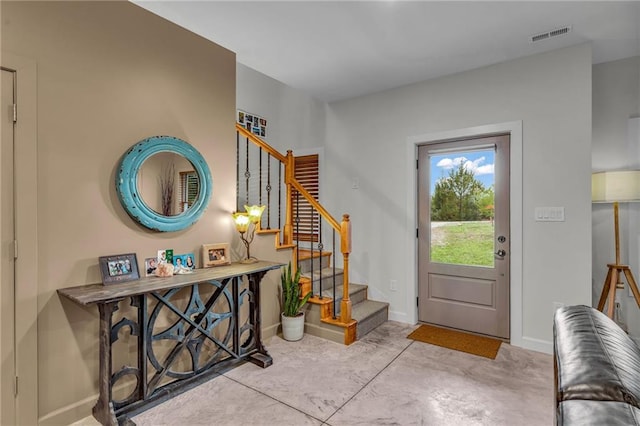 4866 Dabinawa Dr, Mclouth, KS 66054 - foyer entrance featuring concrete flooring, stairs, visible vents, and baseboards
