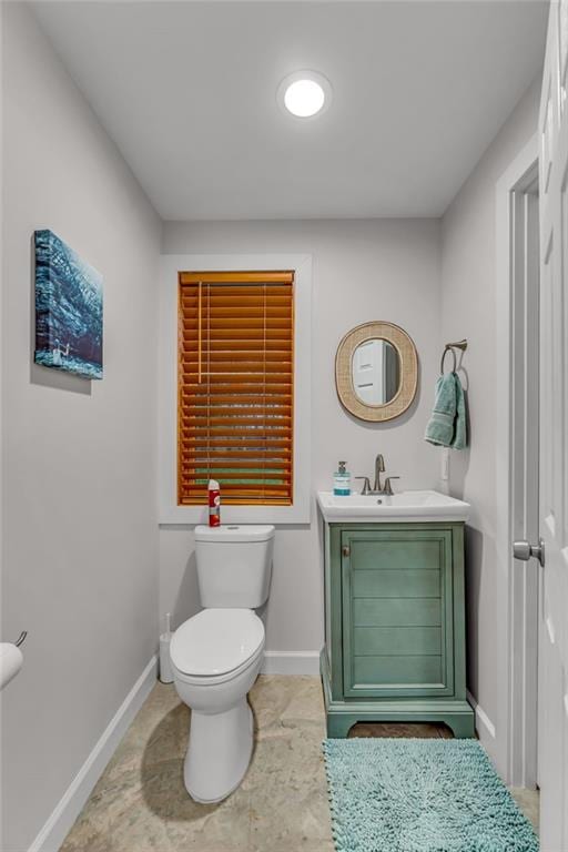 4866 Dabinawa Dr, Mclouth, KS 66054 - bathroom featuring baseboards, toilet, and vanity