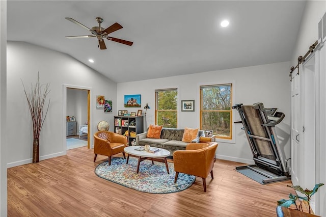4866 Dabinawa Dr, Mclouth, KS 66054 - living room featuring a barn door, lofted ceiling, light wood-type flooring, and a ceiling fan
